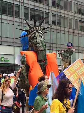 Lady Liberty on 42nd Street models what could be New York's trendiest fashion if sea levels rise. Photo by Hal J. Cohen.