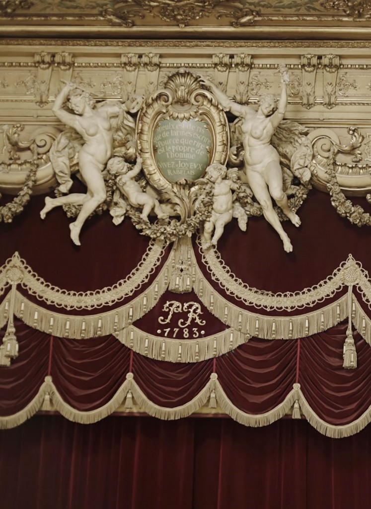 Frolickers above the curtain at the beautiful Theatre du Palais Royal in Paris.  They float around the famous Rabelais quote, "Mieux est de ris que de larmes éscrire - Pour ce que rire est le propre de l'homme," meaning that laughter belongs to man, and better to laugh than to write down your tears.