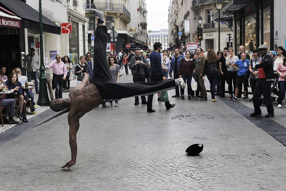 A group of hunky, gravity-defying break dancers have been entertaining rue Montorgeuil for the past several days in Paris.  