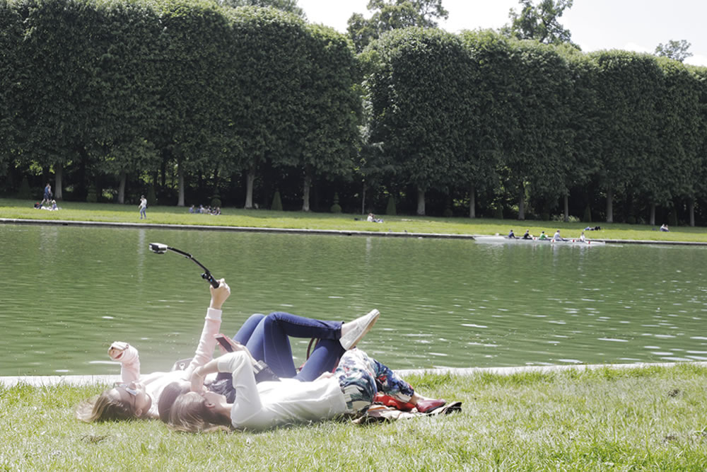 Selfies in the grass at Versailles.