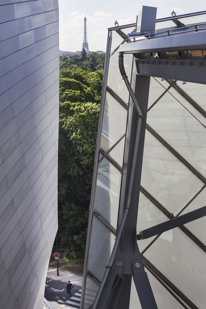 A man leaves the Fondation Louis Vuitton, between what its architect Frank Gehry describes as an iceberg and a glass sail.  The foundation, whose mission is to promote and support contemporary artistic creation, opened to the public in October, 2014 just outside of Paris at the edge of the Bois de Boulogne.