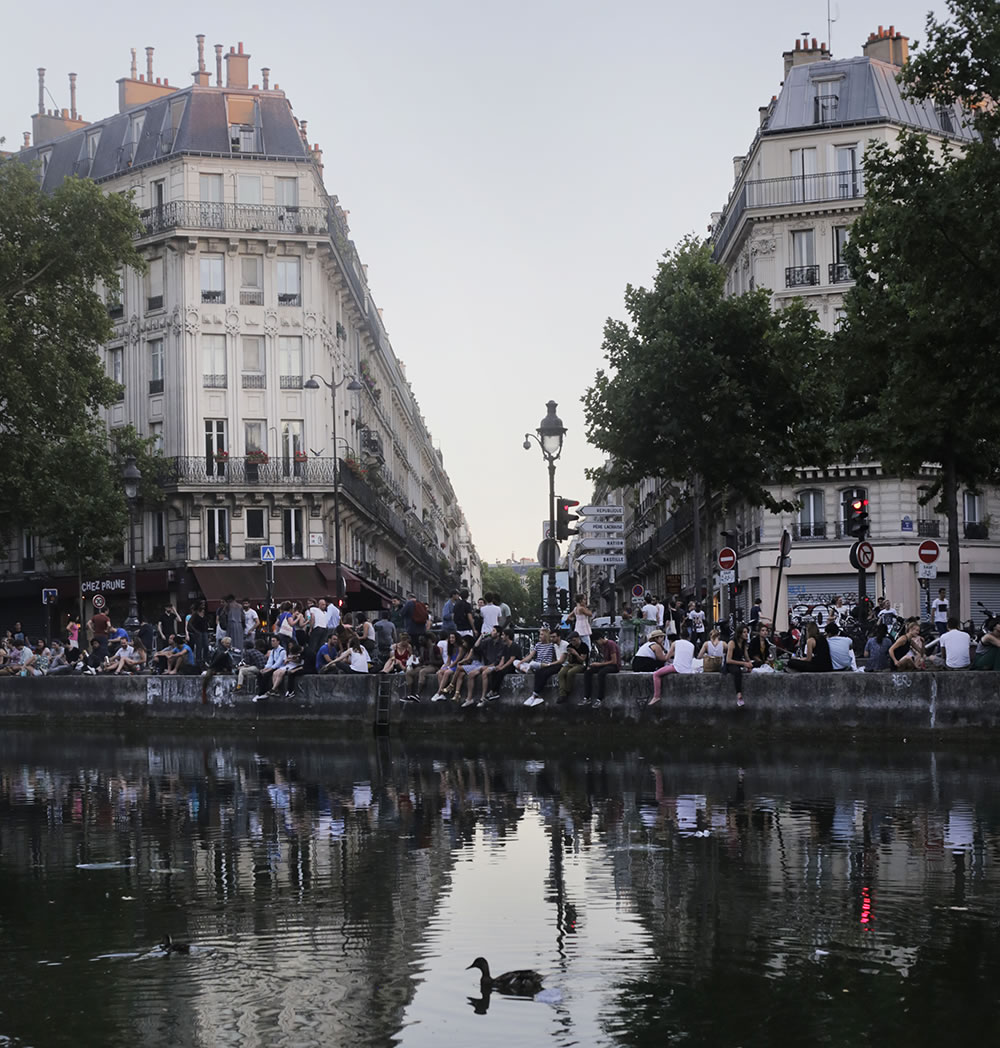 Parisians coping with the heat wave, having apéro picnics along the Canal St. Martin.