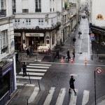 An Invader watches the rainy corner of rue Quincampoix and rue Rambuteau in central Paris.