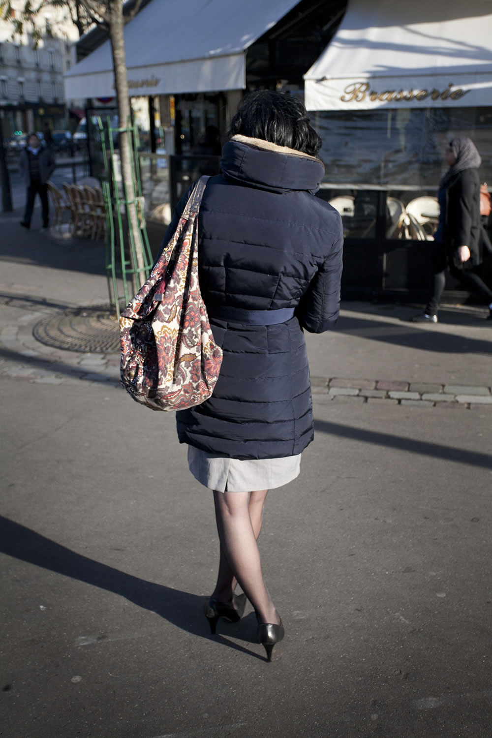 Une Parisienne, texting in front of the corner café, on a crisp autumn afternoon.  