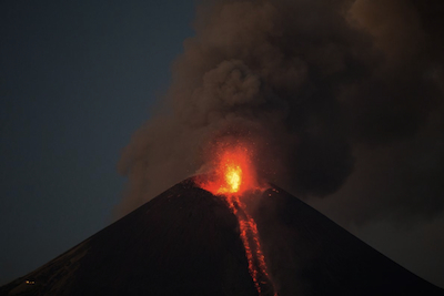 Momotombo emitting lava, gas and ash on Dec. 2, for the first time in more than a century. Photo by Esteban Felix / AP