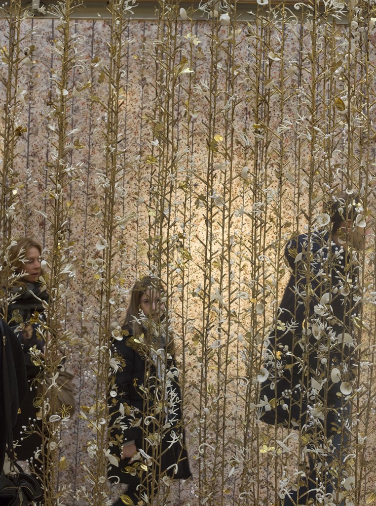 A young girl walks through Kris Ruhs's magical Hanging Garden exhibition with her parents, a restorative break on a busy shopping day in Paris.