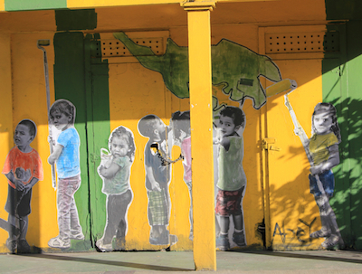 If they can get to it, so can you: wheat-paste mural of children painting a building in downtown Dewey, Isla de Culebra, Puerto Rico. Photo by Amanda Painter.