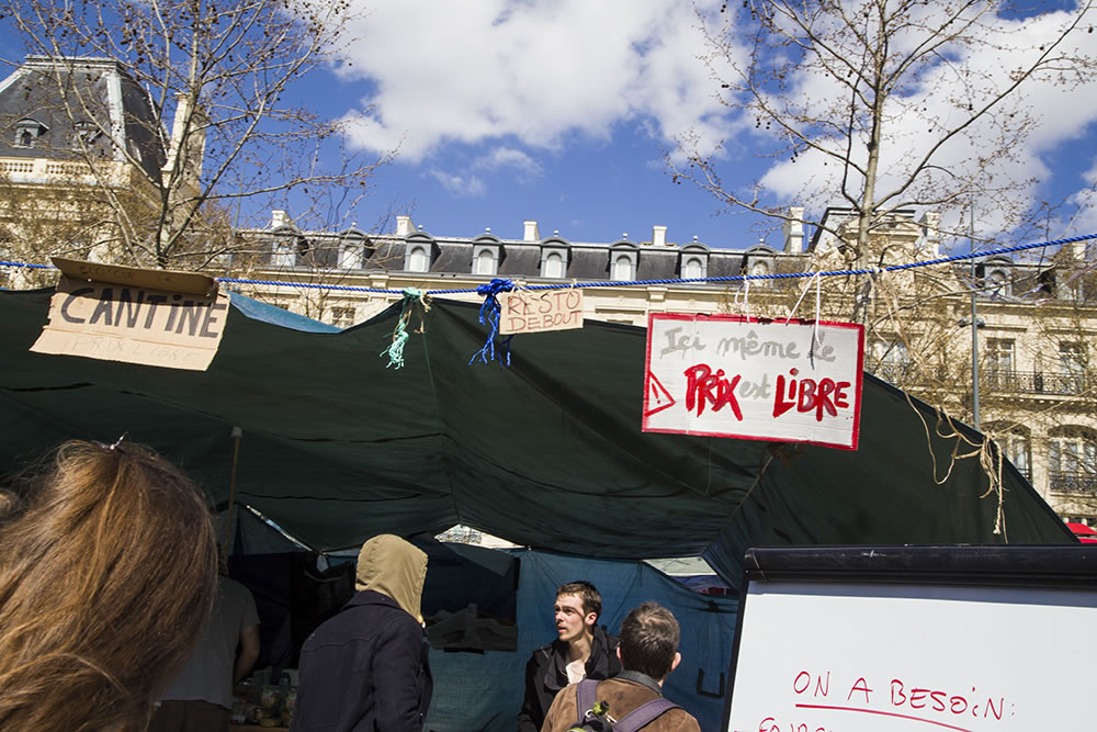 A free restaurant on Paris's Place de la République where, as the sign says, "even the price is free." Sunday night most of the tents and other structures put up by the Nuit Debout (Rise up at night) movement were torn down. The Nuitdeboutistes have been occupying the place since March 31st, and are allowed to stay as long as they don't erect any makeshift structures. For them, time froze the night they occupied the place, making today March 43rd.