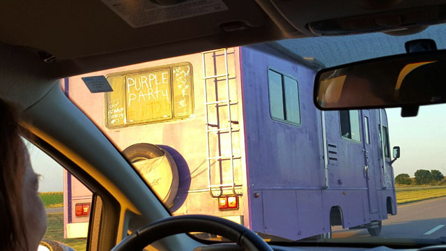 The Purple Party Bus,part of the UpToUs Caravan, on the road in Nebraska. Photo by Ethan Au Green.