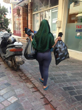 A helper delivering bags of clothes to the Hospital Hotel. Photo by Marcy Franck.