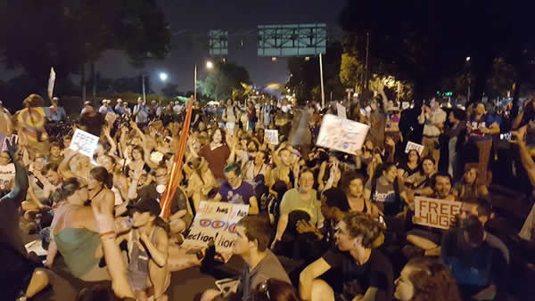 UpToUs protesters occupying the streets outside the Convention Center on the final evening of the DNC with drums, guitars, and a chant of "We're all in this together!" Watch video here.