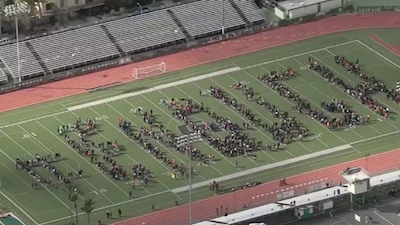 Students in the Granada Hills area of Los Angeles spelled out a message to lawmakers during a Wednesday walkout in response to gun violence, lying silently in the formation of "ENOUGH," with 17 chairs lined up representing the 17 students killed in Parkland, FL, one month ago. Photo by NBC Los Angeles. 