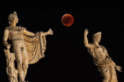 Lunar eclipse between the statues of Hera and Apollo in Athens, Greece, July 27, 2018. Photo by Aris Messins