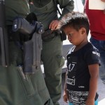 A boy from Honduras is shown being taken into custody by US Border Patrol agents near the US-Mexico Border near Mission, Texas, June 12, 2018. Photo by John Moore